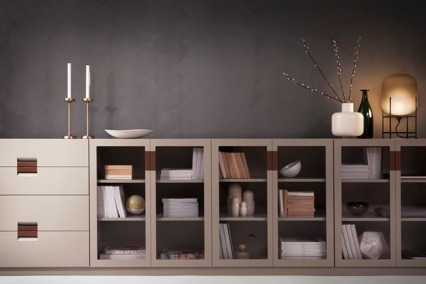 Designed by Anya Sebton & Eva Lilja Löwenhielm 2014.  Storage unit with 1 sliding door in glass. Including two lacquered adjustable shelves. Cabinet with glass doors has no holes at the back.