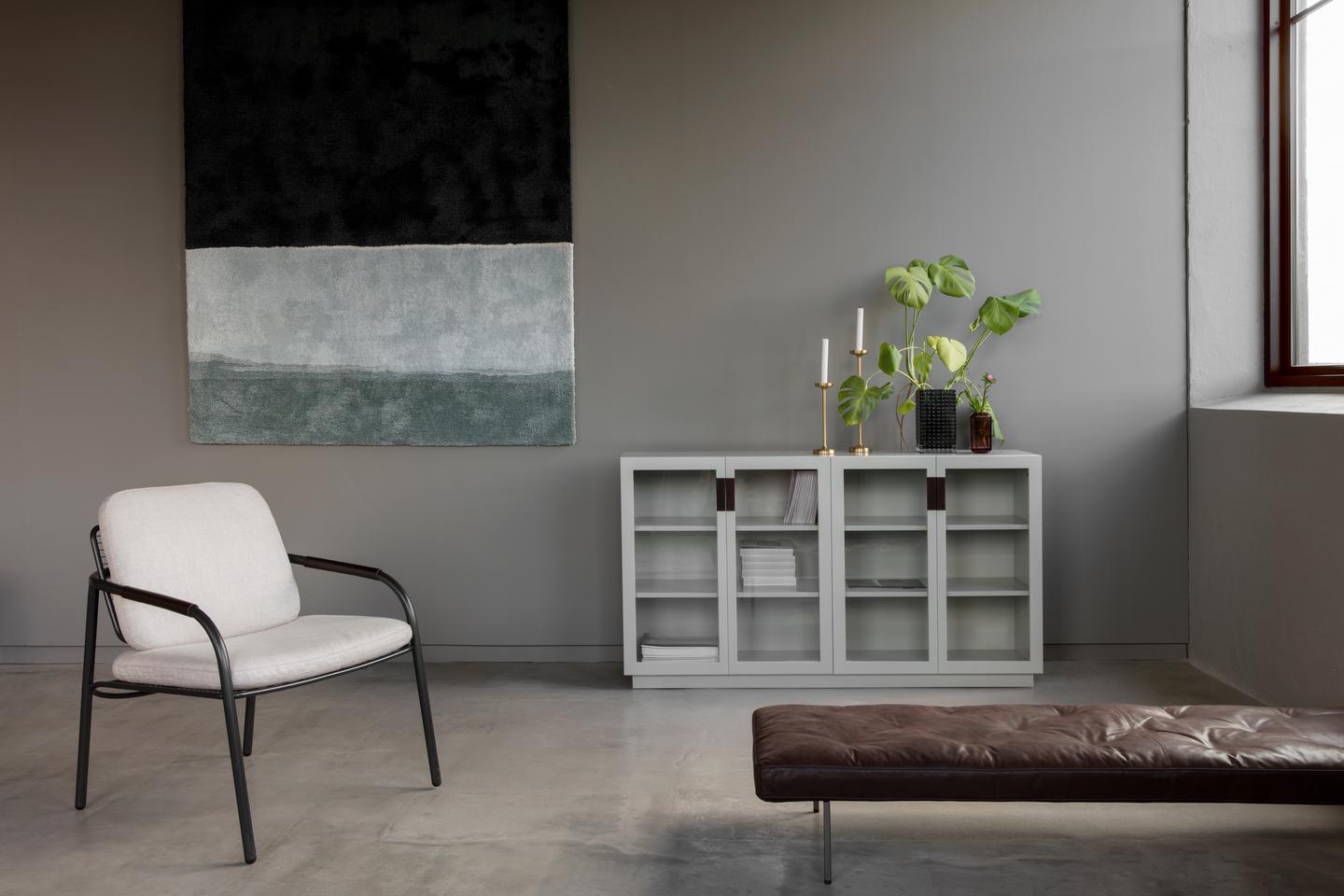 Designed by Anya Sebton and Eva Lilja Löwenhielm 2014.  Storage unit with 2 sliding doors and handles in leather with 2 compartments and 4 lacquered adjustable shelves.