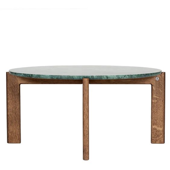 Designed by Daniel Lavonius Jarefeldt 2023.  Iris is a round coffee table with a simple, clean, and functional shape and descriptive details. The base has softly rounded corners where part of the legs embraces the tabletop.