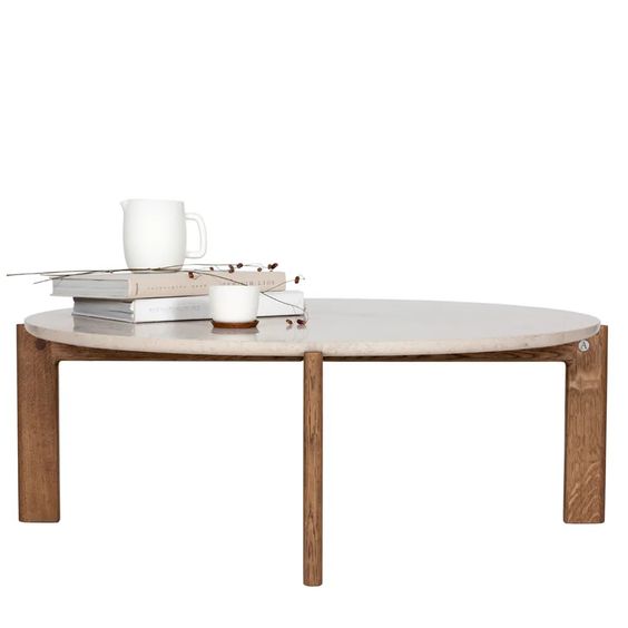 Designed by Daniel Lavonius Jarefeldt 2023.  Iris is a round coffee table with a simple, clean, and functional shape and descriptive details. The base has softly rounded corners where part of the legs embraces the tabletop.