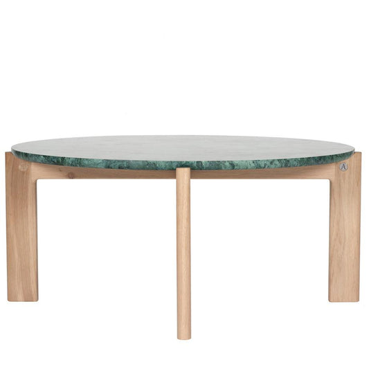 Designed by Daniel Lavonius Jarefeldt 2023.  Iris is a round coffee table with a simple, clean, and functional shape and descriptive details. The base has softly rounded corners where part of the legs embraces the tabletop.