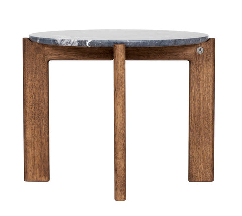 Designed by Daniel Lavonius Jarefeldt 2023.  Iris is a round coffee table with a simple, clean, and functional shape and descriptive details. The base has softly rounded corners where part of the legs embraces the tabletop.