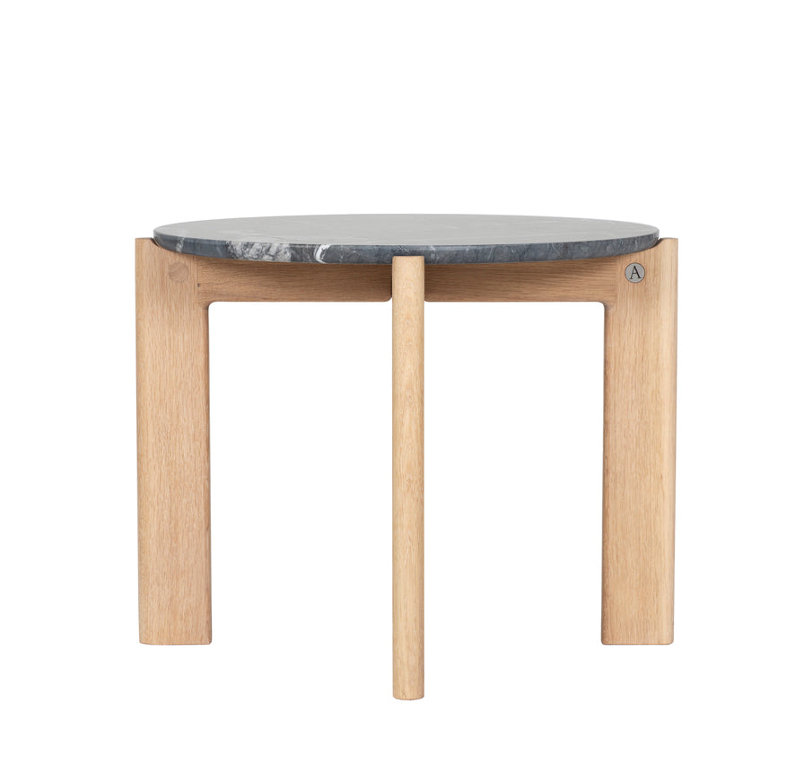 Designed by Daniel Lavonius Jarefeldt 2023.  Iris is a round coffee table with a simple, clean, and functional shape and descriptive details. The base has softly rounded corners where part of the legs embraces the tabletop.
