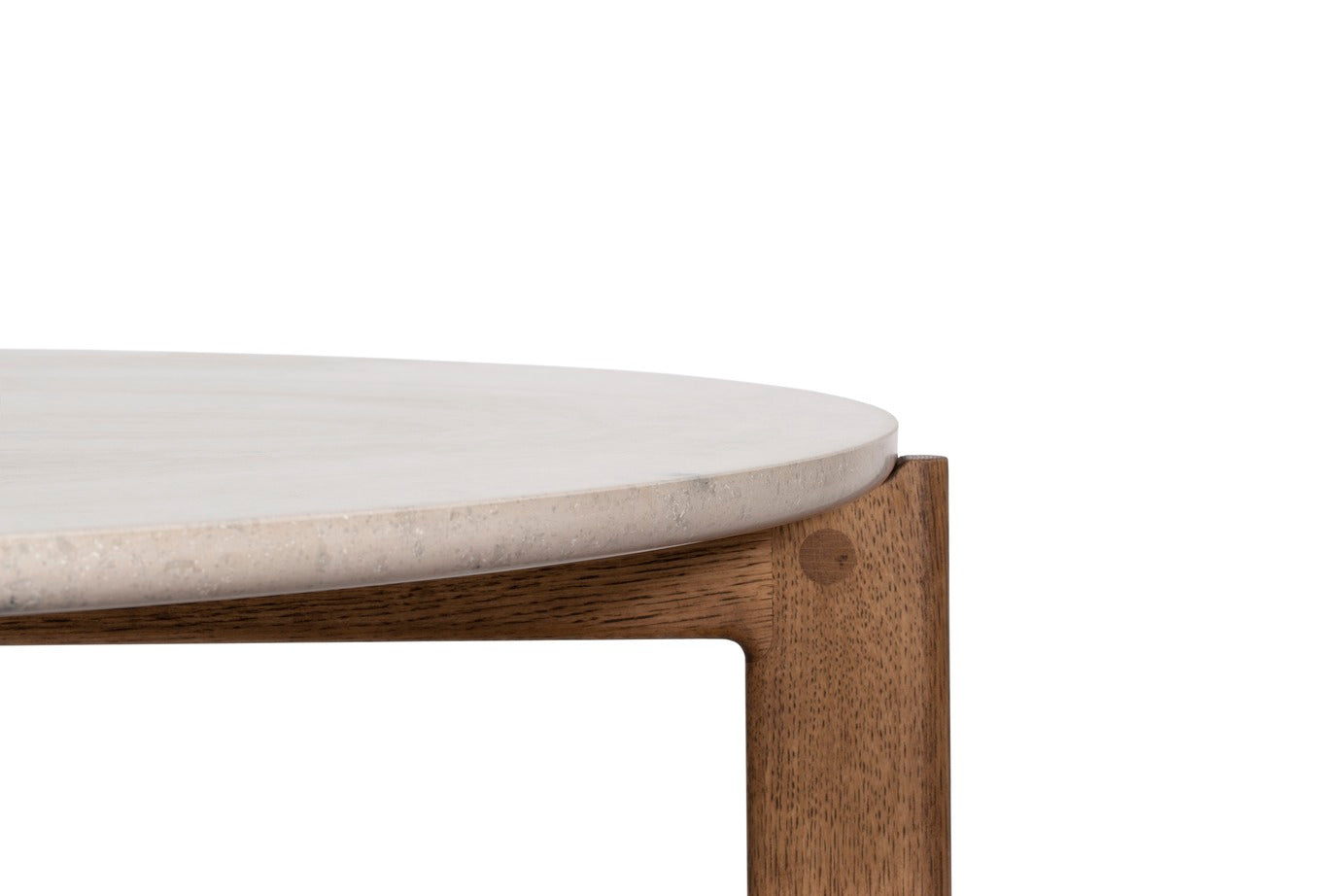 Designed by Daniel Lavonius Jarefeldt 2023.  Iris is a round coffee table with a simple, clean, and functional shape and descriptive details. The base has softly rounded corners where part of the legs embraces the tabletop.