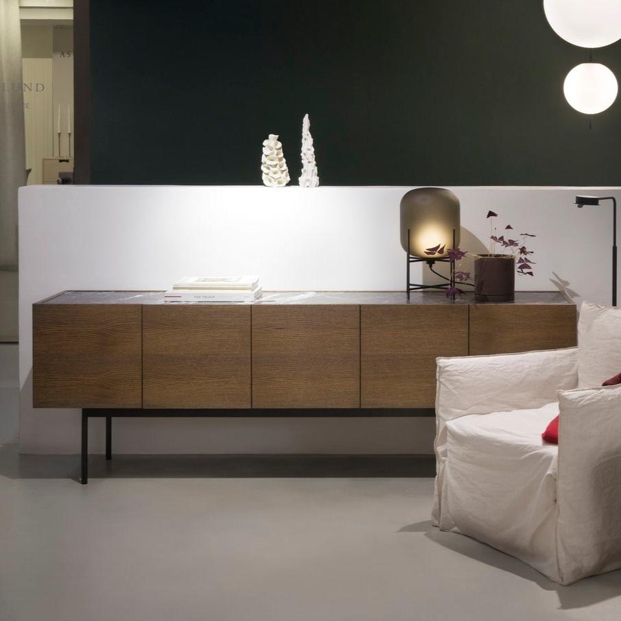 Designed by Broberg and Ridderstråle 2012.  Storage unit with 5 doors and a stand in lacquered metal and stone or glass top.