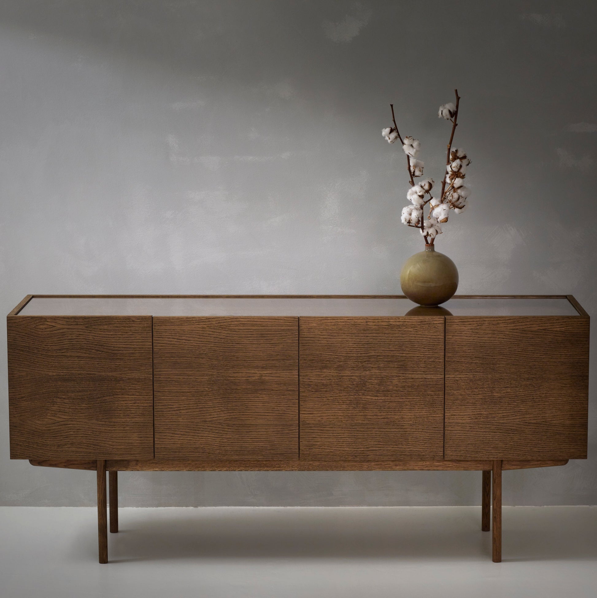 Designed by Broberg and Ridderstråle.  Storage in oak veneer with a wooden base and glass on wood top. Cabinet with two compartments and four doors. One shelf in each compartment.