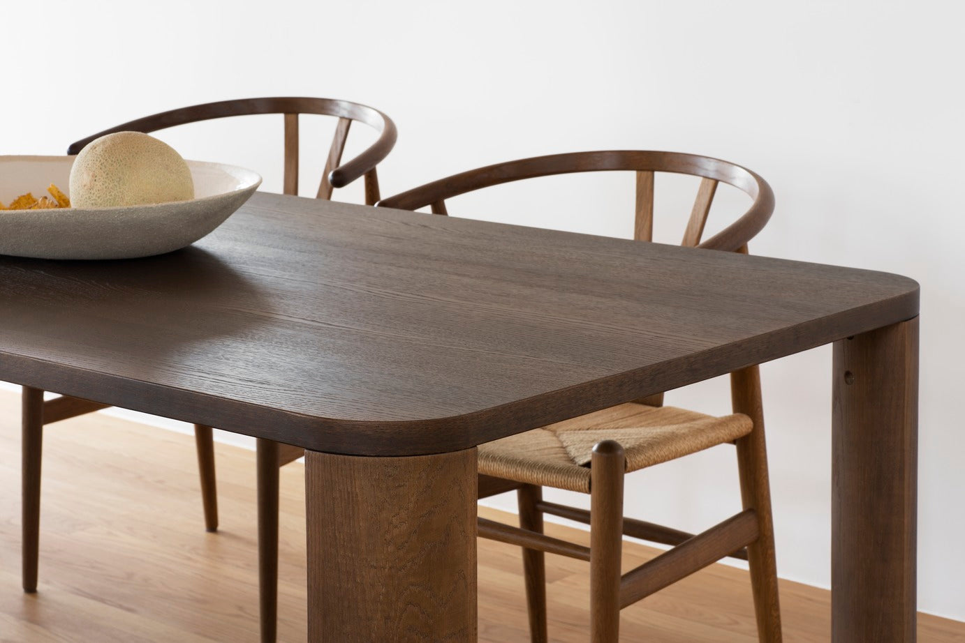 Designed by Moa Sjöberg 2021/22. Moci is a handcrafted and generous table for dining or conference purposes with massive oak legs and an oak veneer top. Available in two sizes and three colors. Made in Sweden.