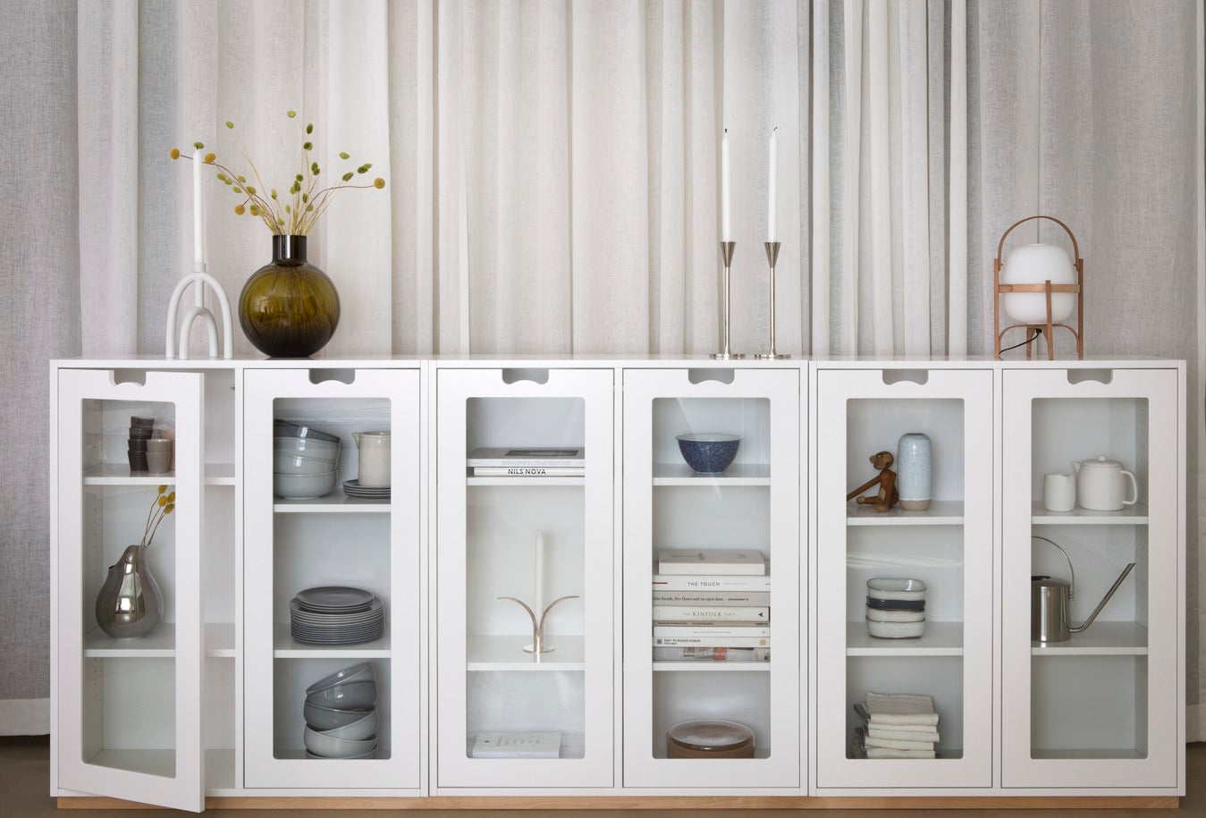 Designed by Thomas Sandell and Jonas Bohlin 1994.   The classic Snow Cabinet E has 2 soft-closing glass doors, a middle partition, and four shelves. Extra shelves can be ordered.  Choose between two depths.