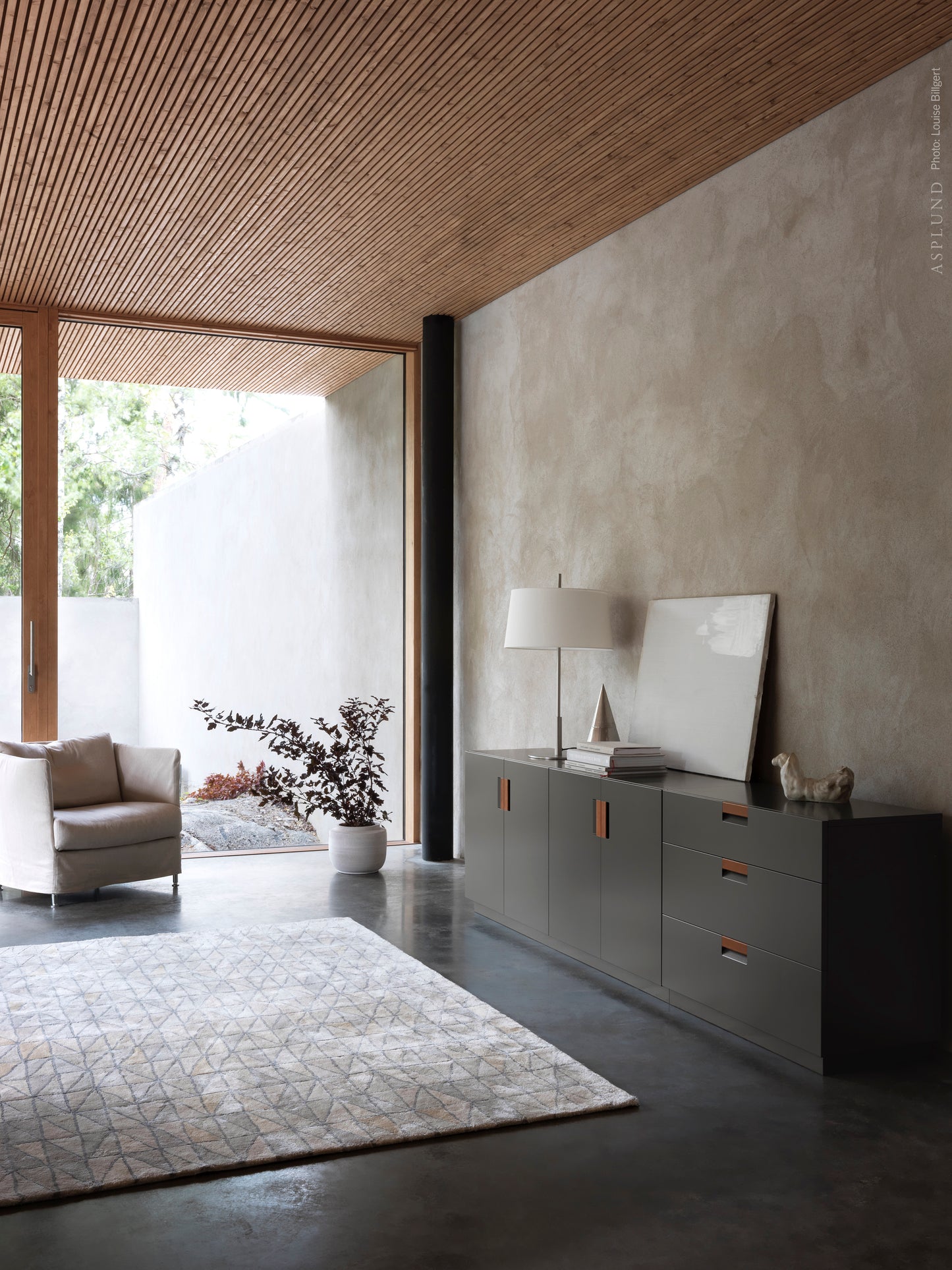 Designed by Anya Sebton and Eva Lilja Löwenhielm 2014.  Storage unit with 2 folding doors and handles in leather with 2 compartments and 2 lacquered shelves. 