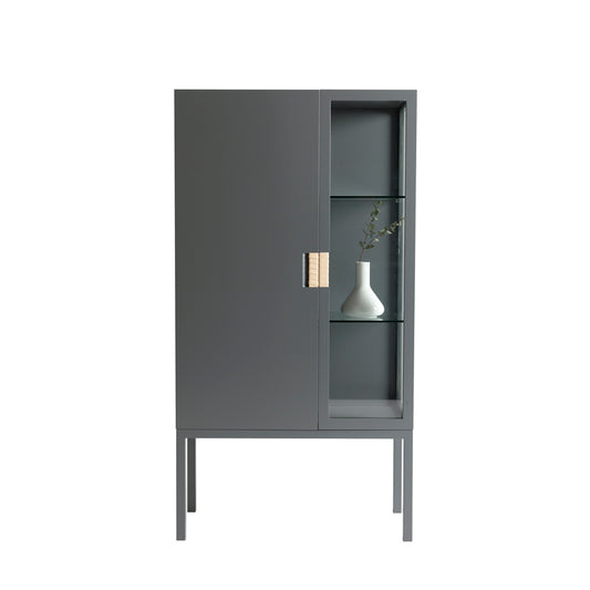 Designed by Anya Sebton and Eva Lilja Löwenhielm 2014.  Glass cabinet in lacquered MDF, stand in lacquered metal. The left side has a covered door and a covered side with two lacquered shelves and the right side has a glass door and a glass side with two glass shelves. Doors have twined leather handles. 