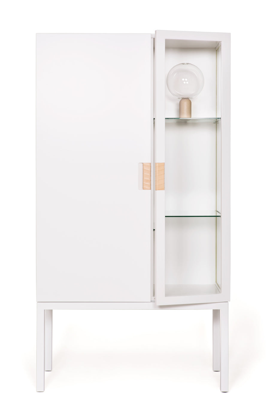 Designed by Anya Sebton and Eva Lilja Löwenhielm 2014.  Glass cabinet in lacquered MDF, stand in lacquered metal. The left side has a covered door and a covered side with two lacquered shelves and the right side has a glass door and a glass side with two glass shelves. Doors have twined leather handles. 