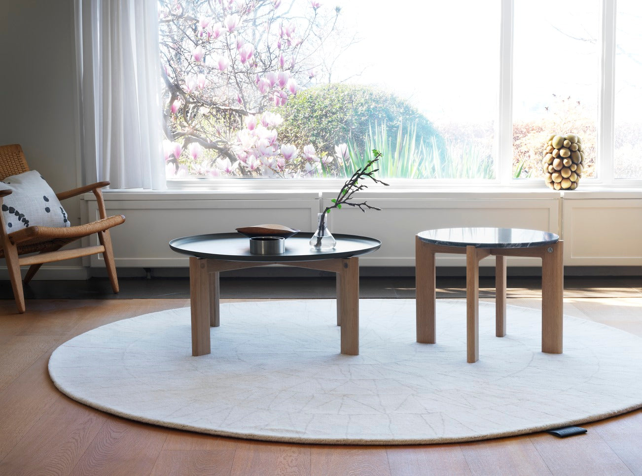 Designed by Daniel Lavonius Jarefeldt 2023.  Iris is a round coffee table with a simple, clean, and functional shape and descriptive details. The base has softly rounded corners where part of the legs embraces the tabletop. 