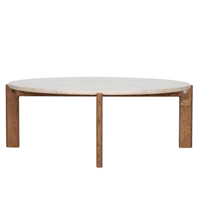 Designed by Daniel Lavonius Jarefeldt 2023.  Iris is a round coffee table with a simple, clean, and functional shape and descriptive details. The base has softly rounded corners where part of the legs embraces the tabletop. 