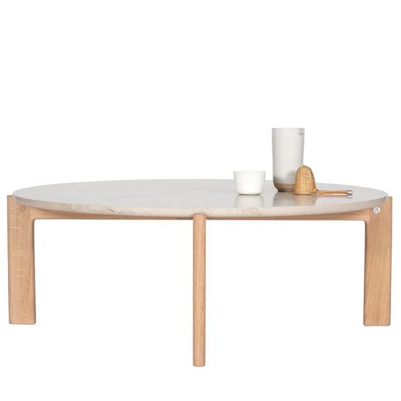 Designed by Daniel Lavonius Jarefeldt 2023.  Iris is a round coffee table with a simple, clean, and functional shape and descriptive details. The base has softly rounded corners where part of the legs embraces the tabletop. 