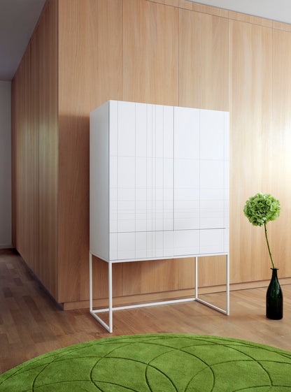 Designed by Claesson Koivisto Rune 2011.  Cabinet in lacquered MDF with lacquered metal stand in the same color. The cabinet has two doors and two drawers—inside a drawer in birch.