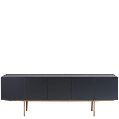 Designed by Broberg and Ridderstråle.  Storage in lacquered oak veneer with a wooden base and stone top. Cabinet with two compartments and four doors. One shelf in each compartment.