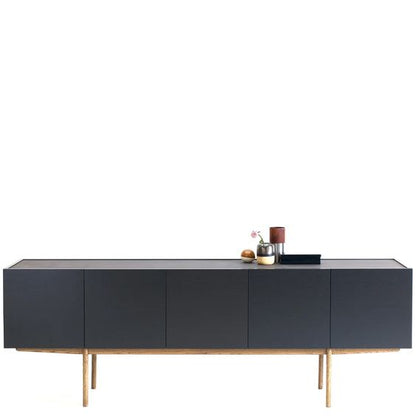 Designed by Broberg and Ridderstråle.  Storage in lacquered oak veneer with a wooden base and stone top. Cabinet with two compartments and four doors. One shelf in each compartment.