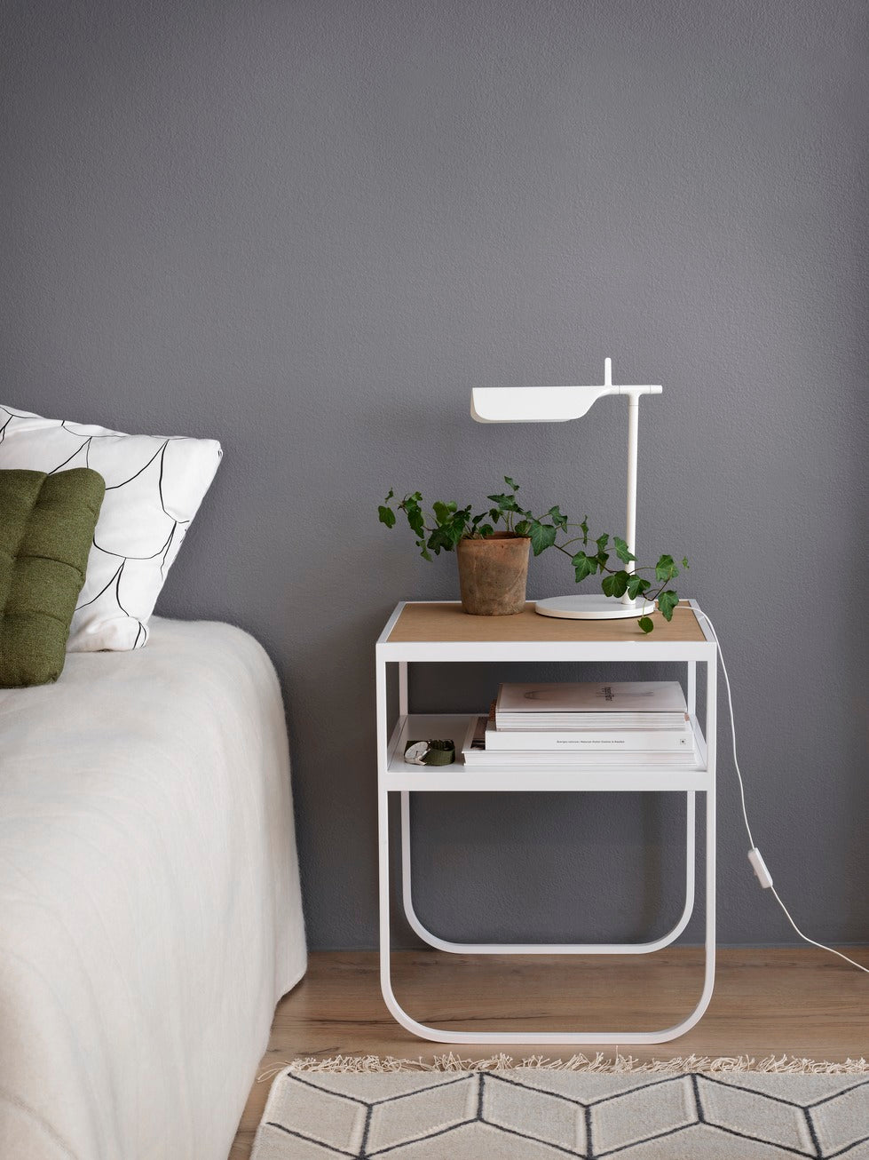 Designed by Broberg and Ridderstråle 2011.  Bedside table with a bent metal structure and solid stone or stained oak top. Choose from multiple color and material options.