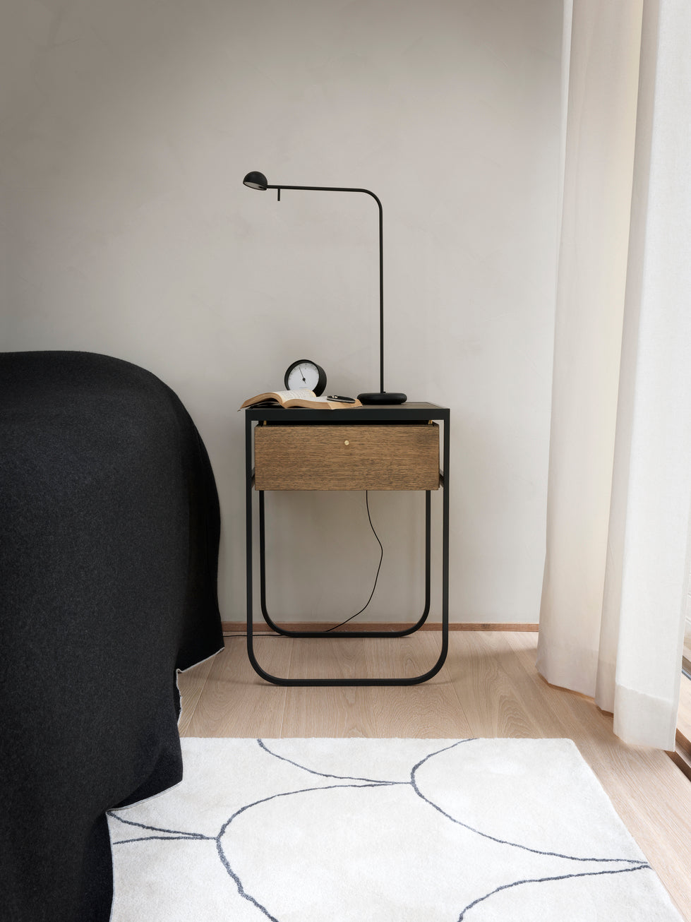 Designed by Broberg and Ridderstråle 2011.  Bedside table with a bent metal structure with a drawer and top in stained oak.