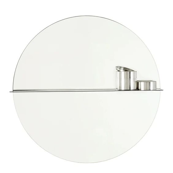 Designed by Anya Sebton and Eva Lilja Löwenhielm 2016.  Round mirror with a horizontal metal shelf. Metal wall fixture included. Screws for attachment against the wall are not included.