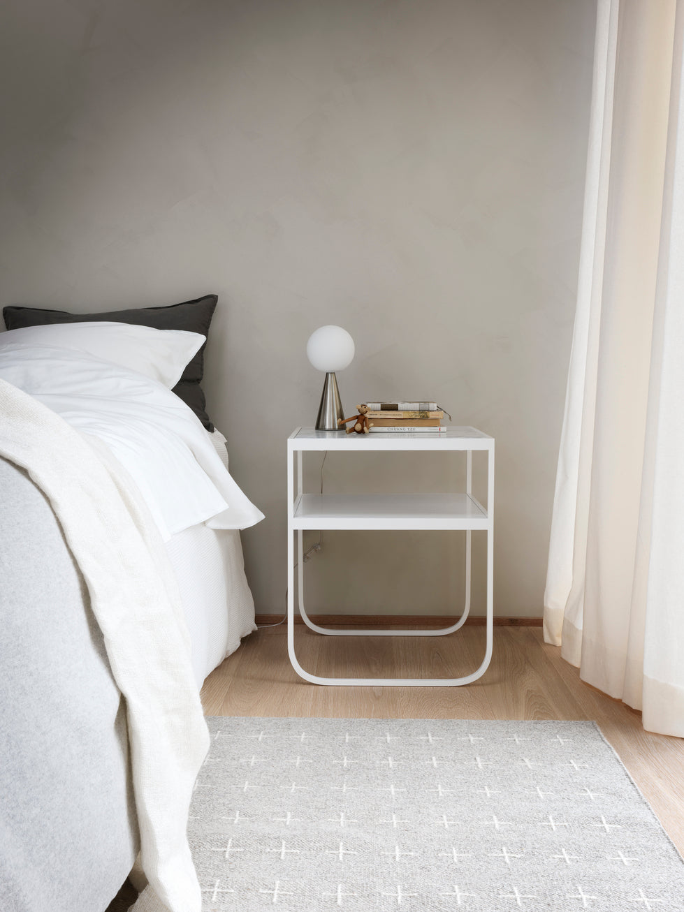 Designed by Broberg and Ridderstråle 2012.  Bedside table with a bent metal structure and solid stone or stained oak top. Choose from multiple color and material options.